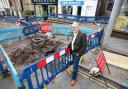 Councillor Ed O'Driscoll next to an exposed broken sewer pipe that caused flooding in Ross-on-Wye