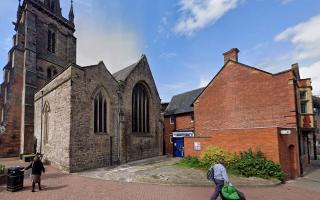 The disused toilet to the right, alongside St Peter's Church, Hereford
