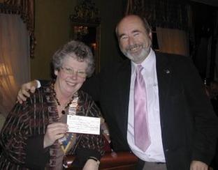 Ledbury Rotary Club’s president Una Morgan receives donation from Rotarian Andrew Perry.