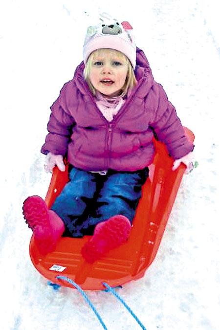 Aimee Rose Powell playing in the snow.