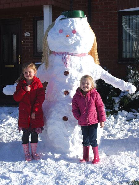 Annie and Paige Wood with their snow woman.