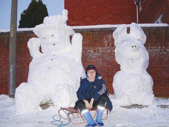 Gareth Swindail-Parry  having fun building a snowman and a snow piggy outside our home in Hereford.
