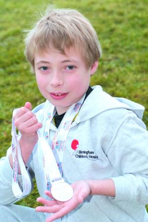 Andrew Fisher-Evans with his medals from the Transplant Games.