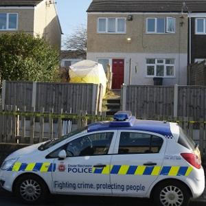 A police car outside a Greater Manchester house where a 64-year-old was found dead
