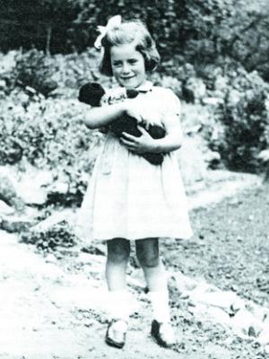 Rosemary Brown at four years old outside her home, Yew Tree Cottage, in How Caple.