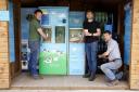 The owners of Whole Moo World with a vending machine