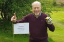 Phil Collins celebrates hitting a hole in one at the 15th hole at Herefordshire Golf Club