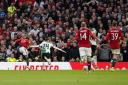 Amad Diallo, left, scored a late winner as Manchester United edged an FA Cup epic (Martin Rickett/PA)