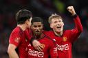 Manchester United’s Marcus Rashford (centre) and team-mates Scott McTominay and Harry Maguire (left) celebrate after beating Liverpool in the FA Cup quarter-final. (Martin Rickett/PA)