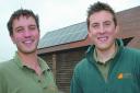 Alex Howard and Joe Perry, from Southern Solar, in front of the solar panels at Butford Organics.