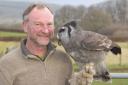 Owner Jay Brittain with Numpy, a Milky Eagle owl who hatched in 1996.