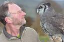 Owner Jay Brittain with Numpy, a Milky Eagle owl who hatched in 1996