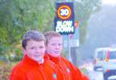 Daniel Pearce (left) and Tom Hughes next to the new speed warning sign close to their school.