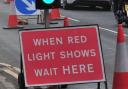 Temporary traffic lights are still on the B4399 almost a year after storm damage. Stock picture