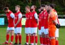 Hereford Pegasus players observe a minute of silence ahead of their game at Wantage Town