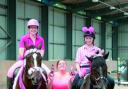 Winners of the Pink Pairs competition, Caroline King on Delilah and Katie Archer on Sam being presented with their ‘pink’ trophies by Becky Harris of Kings EC