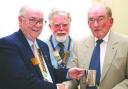 District governor Dave Fenwick presents Cyril Jones (right) with a golf trophy. Centre is City of Hereford club president, Ron Giles.