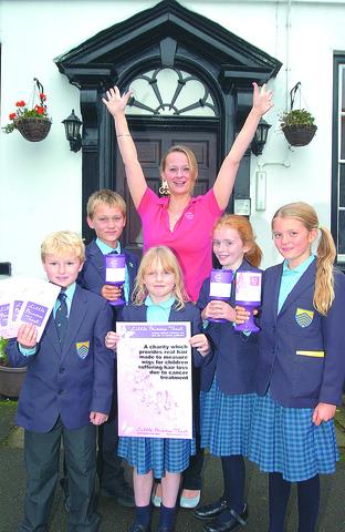 Wendy Tarplee-Morris with Cathedral Junior School students (from left) George Tarplee, Ben Phillips, Bo Mifflin, Emily Prosser and Kezia Roby-Welford, celebrating reaching the target.