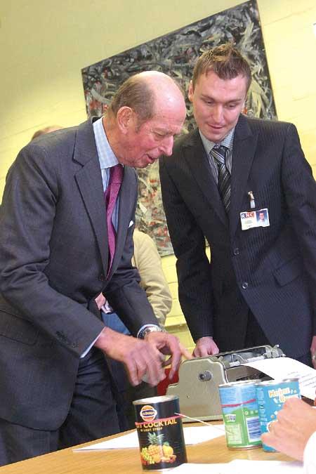 HRH The Duke of Kent uses a braille typewriter under the supervision of Head of Braille Lukasz Kowalski.