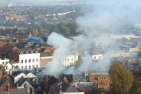 Smoke drifts from the blaze across the city centre.
