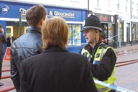 A policeman advises members of the public about the road closures.