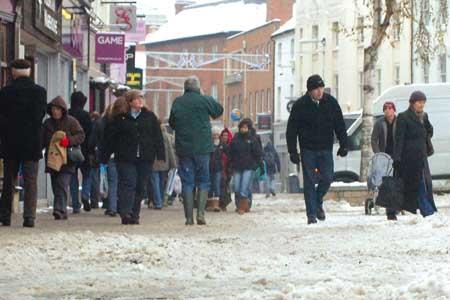 Shoppers brave the snow, ice & sludge in High Town.