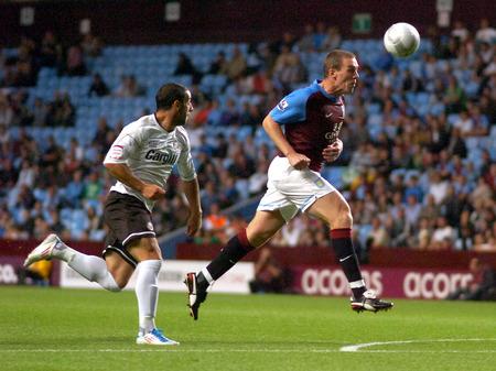 Richard Dunne heads to his keeper under pressure from Stuart Fleetwood.