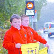 Daniel Pearce (left) and Tom Hughes next to the new speed warning sign close to their school.