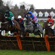 Ladies Day at Hereford Racecourse - The field tackle one of the hurdles in the Enjoy The Cheltenham Festival With MansionBet Novices' Hurdle (Class 4)