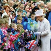 The Queen and Prince Philip visit to Hereford as part of her Diamond Jubilee Tour in 2012. The Queen accepts bouquets of flowers from youngsters at Hereford Cathedral. Picture: Chas Breton