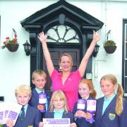 Wendy Tarplee-Morris with Cathedral Junior School students (from left) George Tarplee, Ben Phillips, Bo Mifflin, Emily Prosser and Kezia Roby-Welford, celebrating reaching the target.