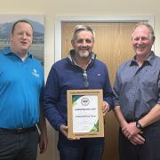 Charles Faram International Hop Awards Harlequin Cup: Will Rogers, left, and Peter Glendinning, right, present the Gold award to Mark Andrews of Townend Farm, based in Bosbury, Ledbury