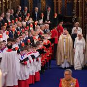 Bishop Richard Jackson accompanies the Queen Consort down the aisle at Westminster Abbey