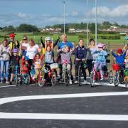 Para-cyclist Daphne Schrager celebrates the opening of Hereford's new cycle track along with families