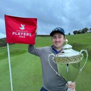 Daniel Brooks with the end of year European Players Tour championship trophy on the 18th green