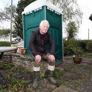 Roger Sell has to use a portable toilet due to his home having no drainage