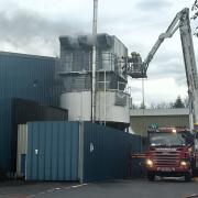Firefighters on an aerial platform tackle the fire at Whitestone Business Park, Hereford