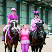 Winners of the Pink Pairs competition, Caroline King on Delilah and Katie Archer on Sam being presented with their ‘pink’ trophies by Becky Harris of Kings EC