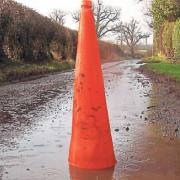 A traffic cone marks a pothole in Lower Breinton.