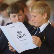 Choristers study the new music. Photograph by Ash Mills