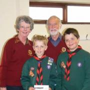 Ledbury Rotary Club president David Tombs and vice president Una Morganth with two of the Scouts, Tom Edwards and Joshua Beck, after donating £1,000 to help refurbish the Scout headquarters.