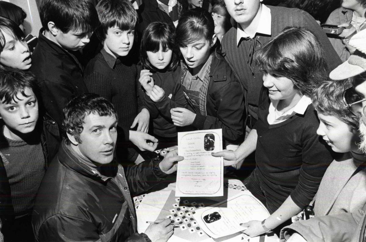 Lewis Collins who played Bodie in TV's 'The Professionals' signing autographs for schoolchildren in Herefordshire.
