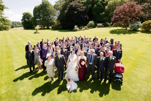 Hereford Times: Ashley and Naomi O'Malley with their wedding party which helped to raise almost 1,400 for St Michael's Hospice. Photo: Russell Lewis Photography.