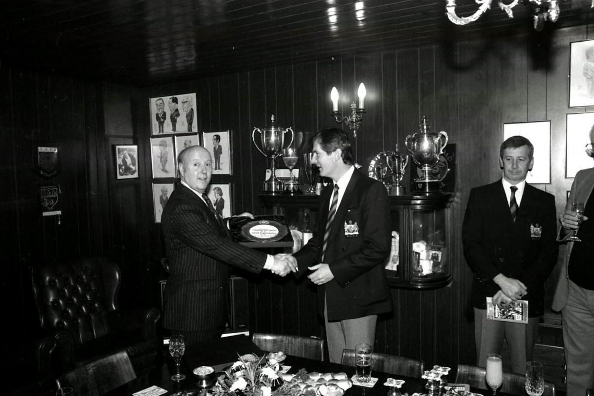 Hereford United Chairman Peter Hill presents Manchester United Chairman Martin Edwards with a gift in the boardroom.