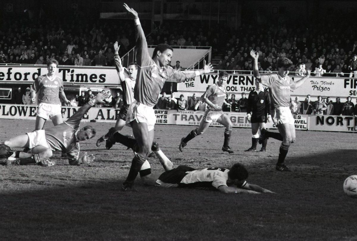 Paul Ince & Manchester players protest their innocence as Hereford appeal for a penalty after Mel Pejic was brought down.