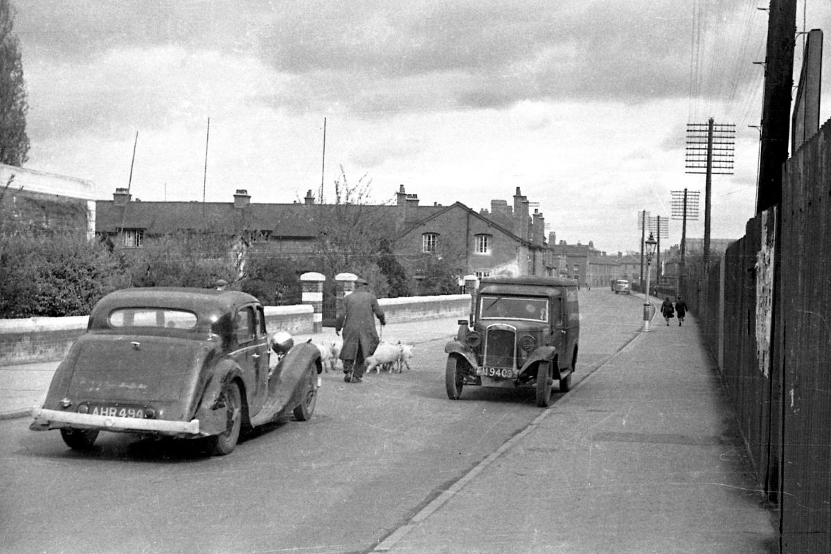 Pigs & their driver blocking cars on Edgar Street as they pass by the public baths (later the Nell Gwynne Theatre) & Edgar Street Athletic Ground. 21st April 1945.