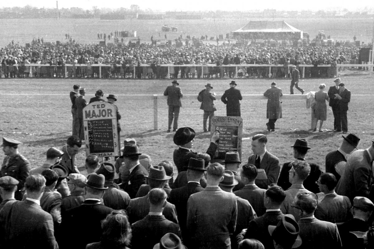 Hereford Steeplechases, Racecourse.  March 30th 1946. Bookmakers taking bets amongst the crowds of punters at the racecourse.