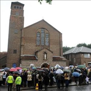 A crowd listen to a service for murdered south London teenager Jimmy Mizen