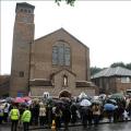 A crowd listen to a service for murdered south London teenager Jimmy Mizen