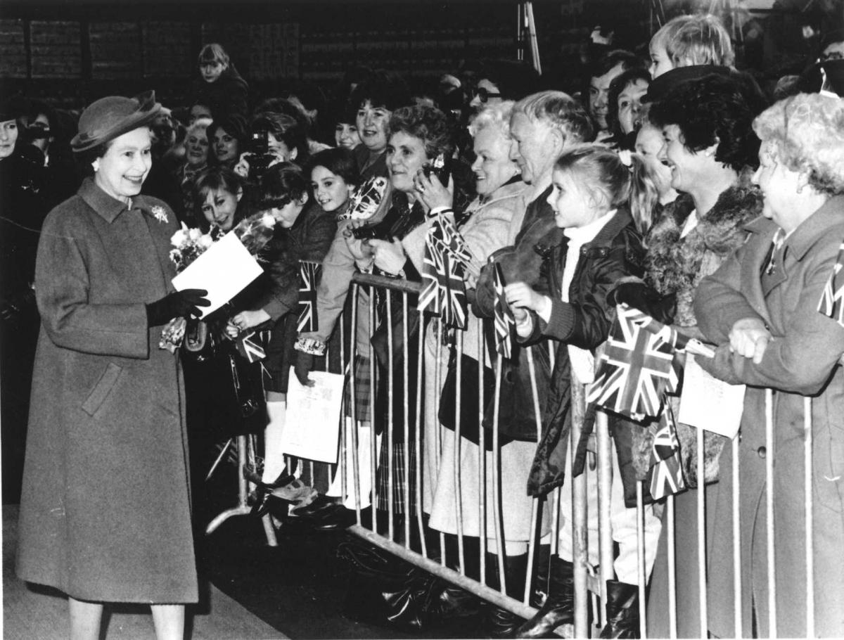 Flag-waving Bulmers employees and their families line up in the bottling hall to greet the Queen, in 1987.
Photo: Derek Evans Archive at Herefordshire Archives and Records Centre